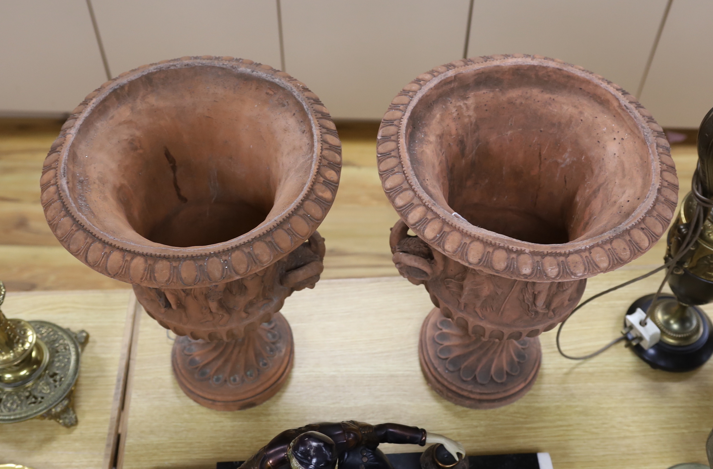 A pair of terracotta neo classical urns, 46cm